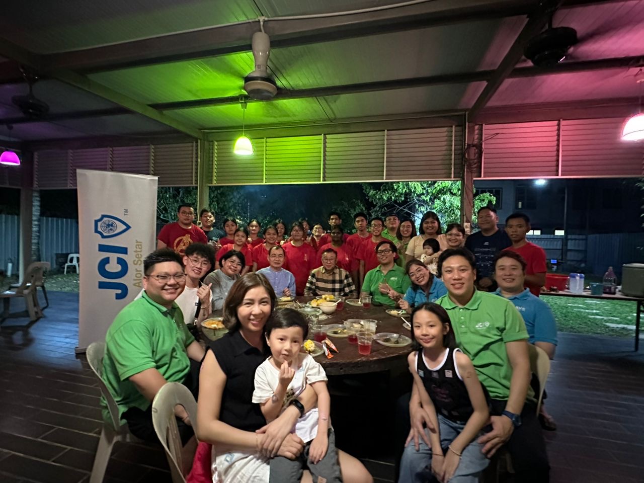 JCI Alor Setar members and families gathered around a table
